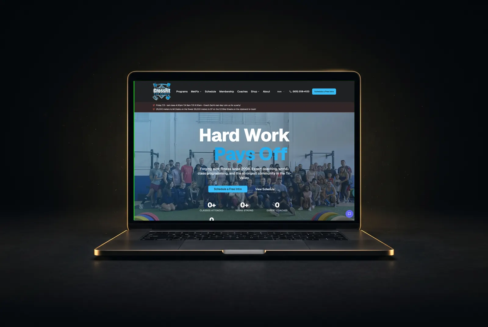 CrossFit San Ramon website displayed on a gold-lit laptop
